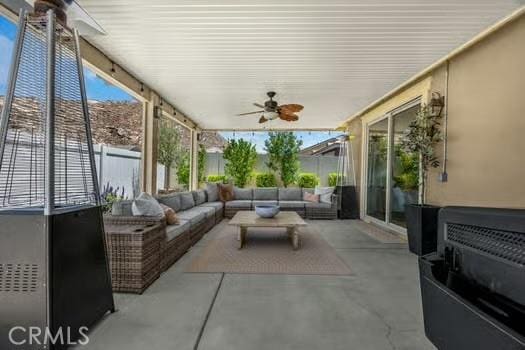 2056 Caltha Way, Perris, CA 92571 - fenced backyard with outdoor lounge area, ceiling fan, and a patio