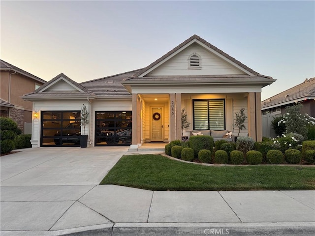 2056 Caltha Way, Perris, CA 92571 - view of front of house with a garage, concrete driveway, a tile roof, covered porch, and a front yard