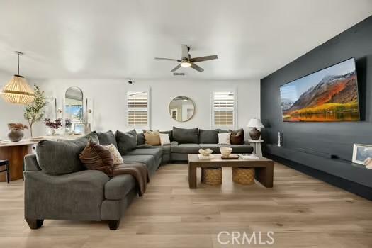 2056 Caltha Way, Perris, CA 92571 - living area with ceiling fan and light wood-style flooring