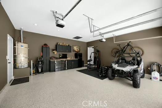 2056 Caltha Way, Perris, CA 92571 - garage with secured water heater and a garage door opener