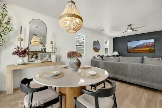 2056 Caltha Way, Perris, CA 92571 - dining area featuring wood finished floors, a ceiling fan, and a chandelier