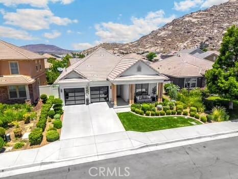 2056 Caltha Way, Perris, CA 92571 - view of front of property featuring a mountain view, concrete driveway, an attached garage, and a tile roof