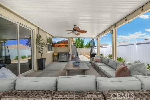 2056 Caltha Way, Perris, CA 92571 - fenced backyard with outdoor lounge area and a ceiling fan