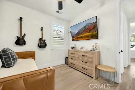2056 Caltha Way, Perris, CA 92571 - living area featuring light wood-type flooring, plenty of natural light, and a ceiling fan