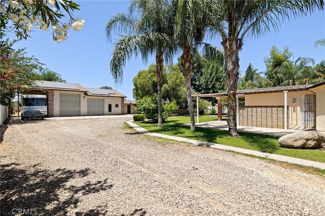 921 Christian Ave, Bakersfield, CA 93314 - view of front of house with solar panels, stucco siding, and driveway