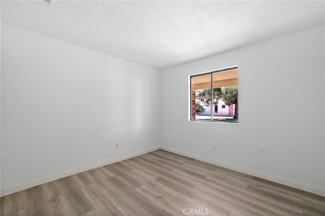 921 Christian Ave, Bakersfield, CA 93314 - spare room featuring wood finished floors and a textured ceiling