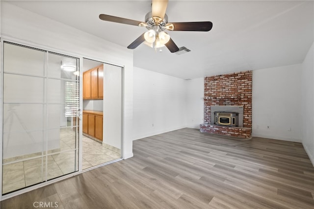 921 Christian Ave, Bakersfield, CA 93314 - unfurnished living room with light wood finished floors, ceiling fan, and a fireplace