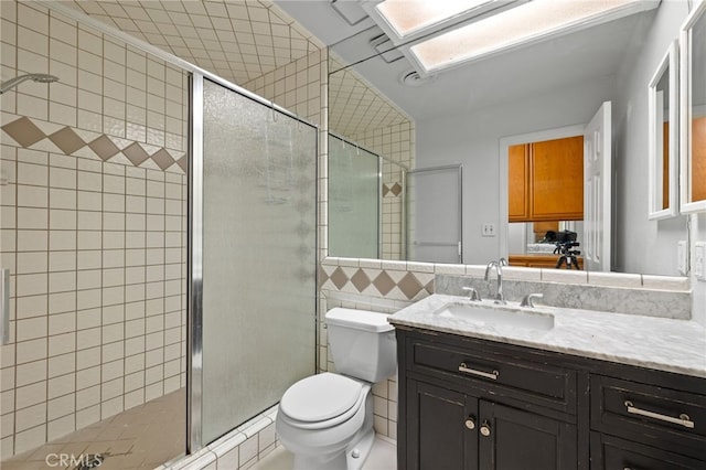 921 Christian Ave, Bakersfield, CA 93314 - bathroom featuring vanity, a stall shower, and tile walls