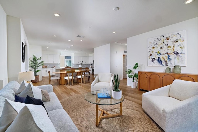 6140 Colt Pl Unit 104, Carlsbad, CA 92009 - living room featuring light wood-style floors and recessed lighting