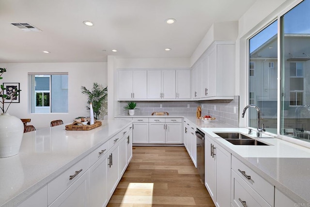 6140 Colt Pl Unit 104, Carlsbad, CA 92009 - kitchen featuring plenty of natural light, dishwasher, light countertops, recessed lighting, and white cabinets