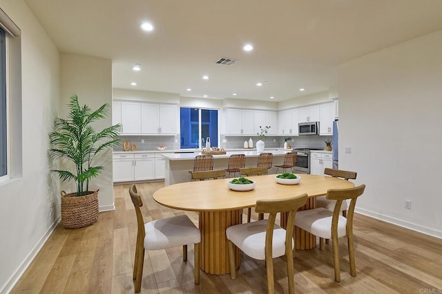 6140 Colt Pl Unit 104, Carlsbad, CA 92009 - dining room featuring light wood finished floors and recessed lighting