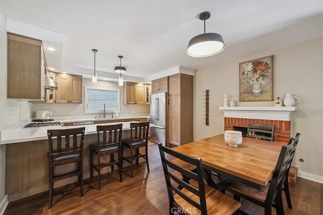 2248 E Chevy Chase Dr, Glendale, CA 91206 - dining space with dark wood finished floors, a fireplace, and recessed lighting