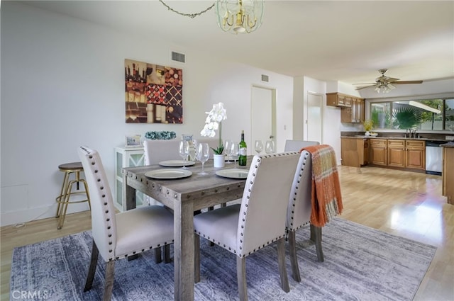 4931 Saint Andrews Ave, Buena Park, CA 90621 - dining space with light wood-style flooring, a chandelier, and ceiling fan