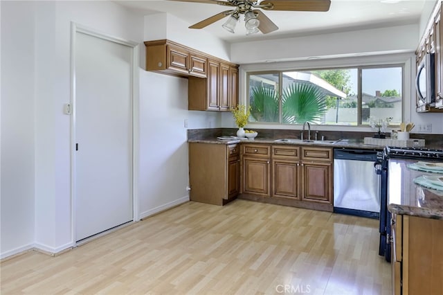 4931 Saint Andrews Ave, Buena Park, CA 90621 - kitchen with stainless steel appliances, light wood-style flooring, brown cabinets, and a ceiling fan