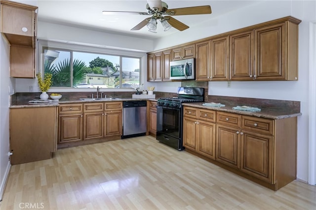 4931 Saint Andrews Ave, Buena Park, CA 90621 - kitchen featuring appliances with stainless steel finishes, light wood-style floors, brown cabinetry, and ceiling fan