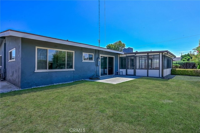 4931 Saint Andrews Ave, Buena Park, CA 90621 - back of property with a yard, a patio area, stucco siding, and a sunroom