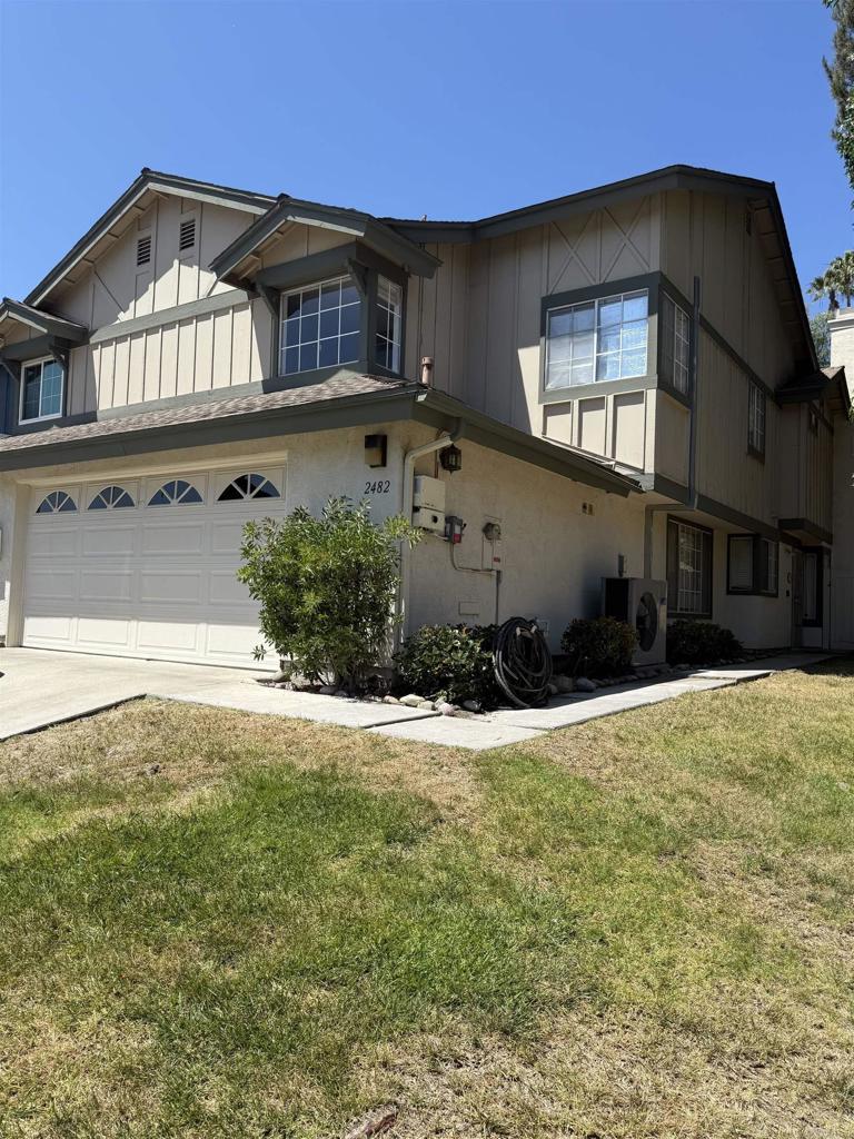 2482 Manzana Way, San Diego, CA 92139 - view of front facade with board and batten siding, a garage, a front yard, and driveway