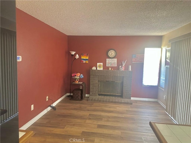 3539 Castaic, Riverside, CA 92501 - living area with wood finished floors, a textured ceiling, and a fireplace