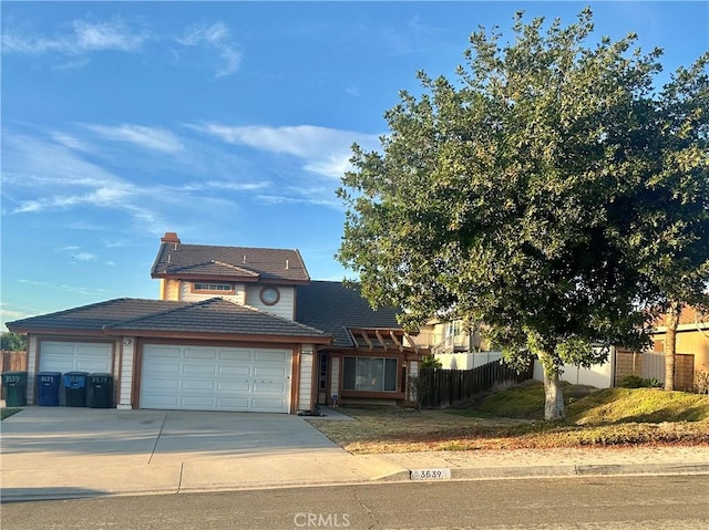 3539 Castaic, Riverside, CA 92501 - traditional home with a garage, concrete driveway, a tiled roof, and a chimney