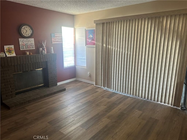 3539 Castaic, Riverside, CA 92501 - unfurnished living room with wood finished floors, a brick fireplace, and a textured ceiling