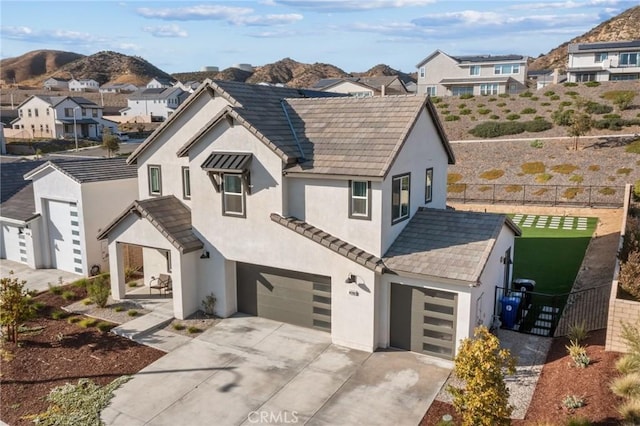 28709 Wildflower, Castaic, CA 91384 - view of front of house with an attached garage, stucco siding, a residential view, driveway, and a mountain view