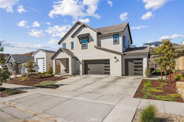 28709 Wildflower, Castaic, CA 91384 - view of front of property with an attached garage, concrete driveway, stucco siding, and a tile roof