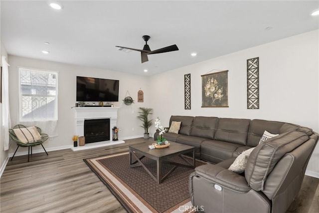 28709 Wildflower, Castaic, CA 91384 - living area with wood finished floors, ceiling fan, recessed lighting, and a fireplace with raised hearth