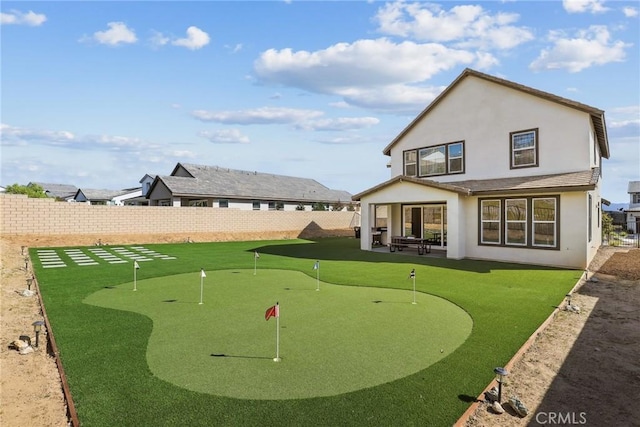 28709 Wildflower, Castaic, CA 91384 - rear view of house featuring a putting green, a fenced backyard, a patio area, and stucco siding