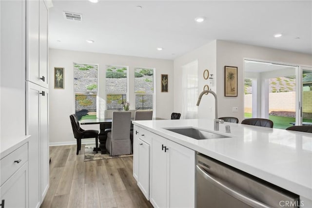 28709 Wildflower, Castaic, CA 91384 - kitchen with dishwasher, light countertops, light wood-style flooring, white cabinets, and recessed lighting