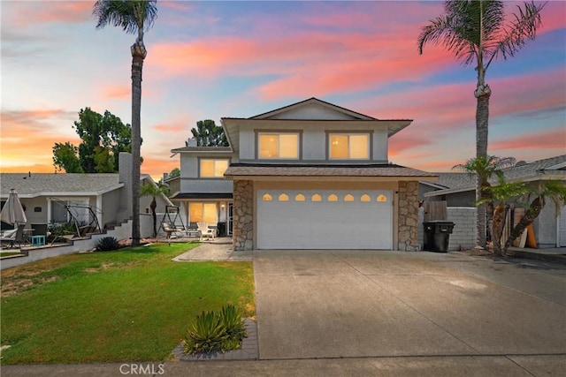 3911 Bryce Ct, Chino, CA 91710 - view of front of house featuring stone siding, concrete driveway, a garage, a lawn, and stucco siding