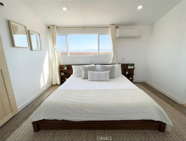 3191 Pearl Springs Ave Unit 29, Palms, CA 92277 - bedroom featuring an AC wall unit, recessed lighting, and wood finished floors