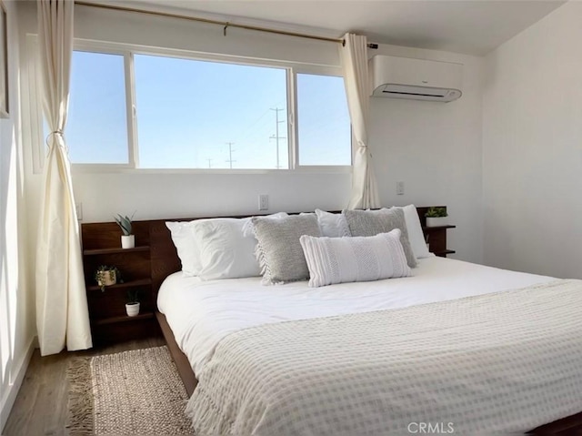 3191 Pearl Springs Ave Unit 29, Palms, CA 92277 - bedroom featuring a wall unit AC, wood finished floors, and multiple windows