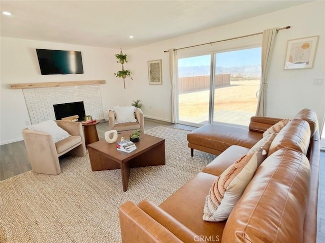 3191 Pearl Springs Ave Unit 29, Palms, CA 92277 - living area featuring wood finished floors, recessed lighting, and a brick fireplace