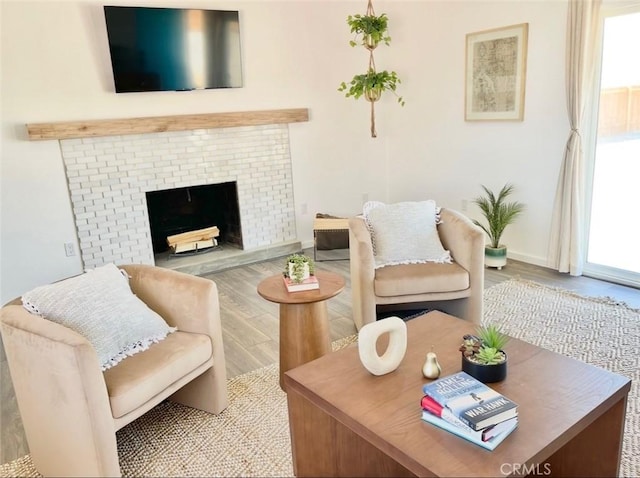 3191 Pearl Springs Ave Unit 29, Palms, CA 92277 - living area featuring plenty of natural light, wood finished floors, and a fireplace