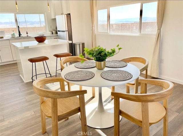3191 Pearl Springs Ave Unit 29, Palms, CA 92277 - dining space featuring light wood-style floors and baseboards