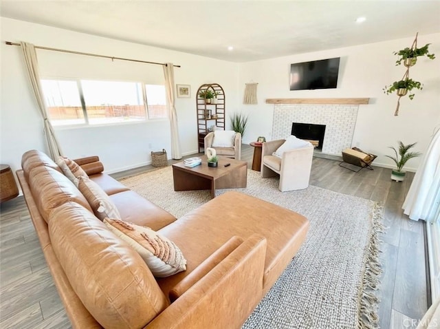 3191 Pearl Springs Ave Unit 29, Palms, CA 92277 - living room with a tiled fireplace, wood finished floors, and recessed lighting