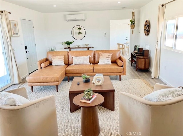 3191 Pearl Springs Ave Unit 29, Palms, CA 92277 - living area with a wall unit AC, light wood-style flooring, and recessed lighting