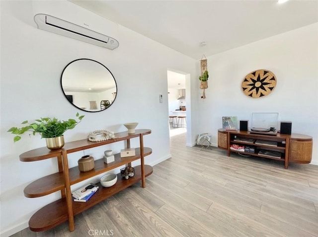 3191 Pearl Springs Ave Unit 29, Palms, CA 92277 - hallway featuring an AC wall unit and light wood-style flooring
