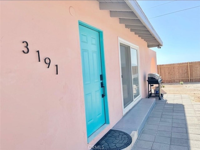 3191 Pearl Springs Ave Unit 29, Palms, CA 92277 - doorway to property featuring stucco siding
