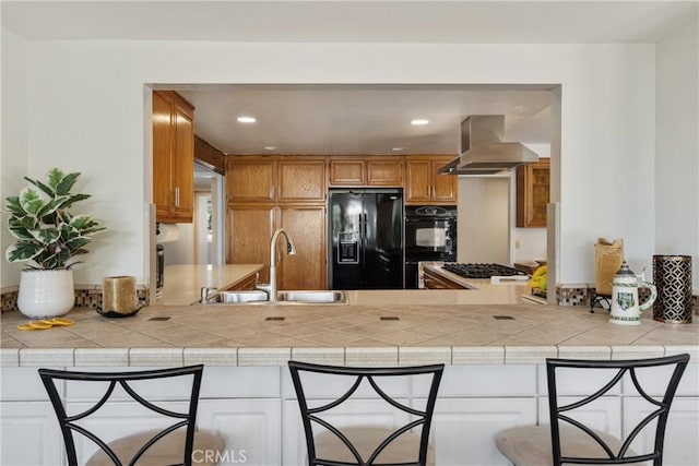 8652 Surrey Ln, Rancho Cucamonga, CA 91701 - kitchen with black appliances, wall chimney exhaust hood, a peninsula, recessed lighting, and light countertops