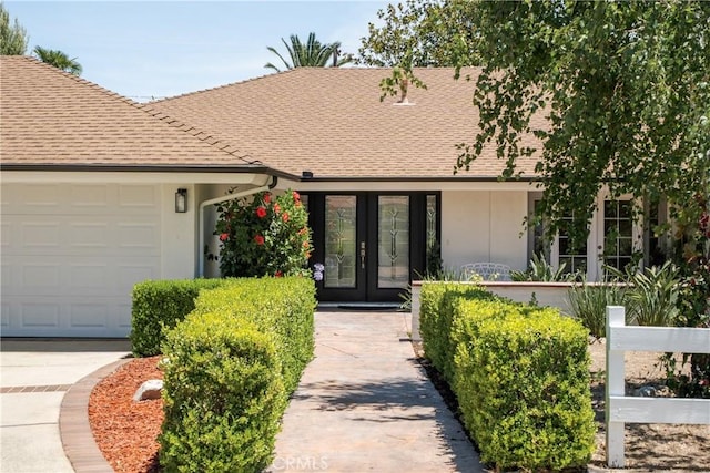 8652 Surrey Ln, Rancho Cucamonga, CA 91701 - view of front of house with french doors, a shingled roof, a garage, and stucco siding
