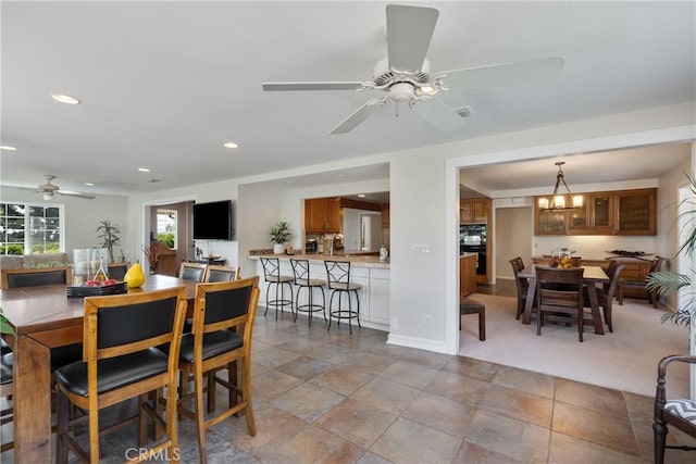 8652 Surrey Ln, Rancho Cucamonga, CA 91701 - dining space with a ceiling fan, recessed lighting, and stone finish flooring