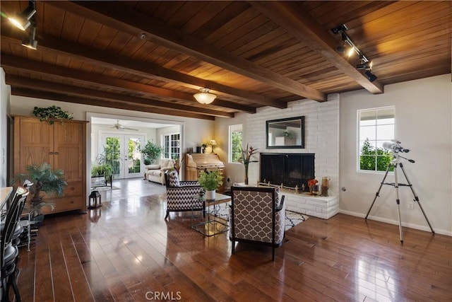 8652 Surrey Ln, Rancho Cucamonga, CA 91701 - living area featuring a wood ceiling with exposed beams, dark wood finished floors, healthy amount of natural light, track lighting, and a brick fireplace