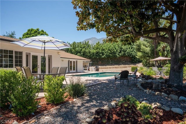 8652 Surrey Ln, Rancho Cucamonga, CA 91701 - swimming pool with french doors, a patio area, and a mountain view