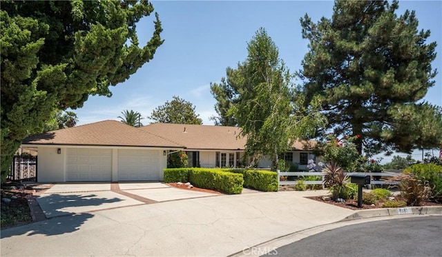 8652 Surrey Ln, Rancho Cucamonga, CA 91701 - ranch-style house featuring a garage, driveway, and stucco siding