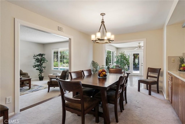 8652 Surrey Ln, Rancho Cucamonga, CA 91701 - dining space with light colored carpet, a chandelier, and ceiling fan