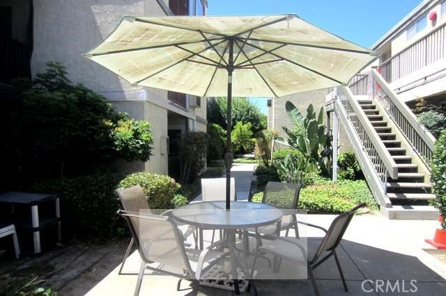 6675 Mission Gorge Rd Unit A114, San Diego, CA 92120 - view of patio / terrace with stairway and outdoor dining space