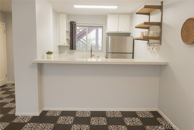 6675 Mission Gorge Rd Unit A114, San Diego, CA 92120 - kitchen featuring freestanding refrigerator, open shelves, white cabinetry, and light countertops