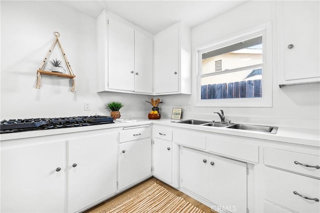 16271 Fairway Ln, Huntington Beach, CA 92649 - kitchen with black gas cooktop, white cabinets, and light countertops