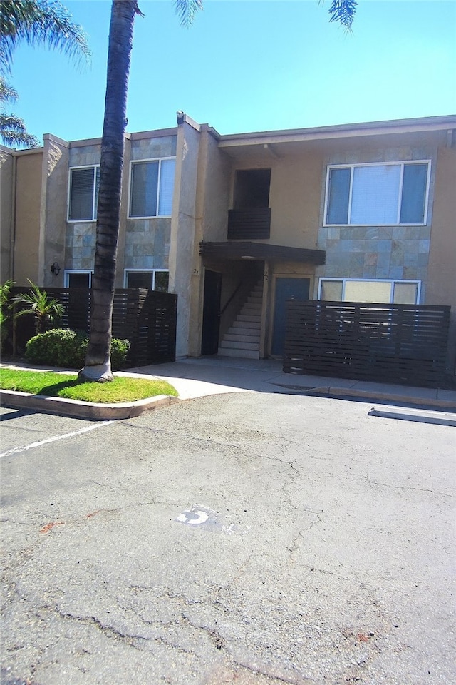 1386 E Madison Ave Unit 21, El Cajon, CA 92021 - view of property with stairway and uncovered parking